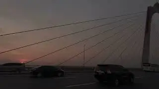 Explore the deserted cable-stayed bridge in Hanoi at sunset by motorbike.