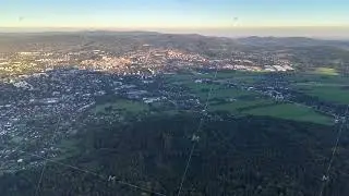 Aerial view of a vibrant city next to lush, green fields, creating a picturesque landscape