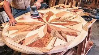 A young carpenter creates a special round wooden table from recycled wood