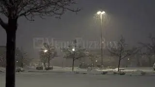 Stock Video - Heavy snow falling in empty parking lot during storm warning