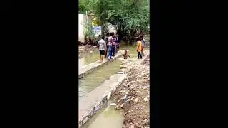 village boys swimming in canal in summer time