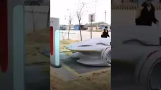Wireless charging at a Tesla station with the new Apple car.
