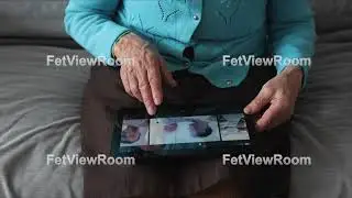 Hands of the old woman and electronic tablet