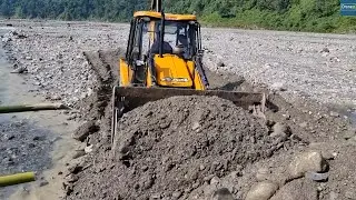 For Hilly Villagers Regular Life Bridging Mountain River with JCB Backhoe