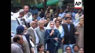 Benazir Bhutto speaking outside her home via megaphone after house arrest