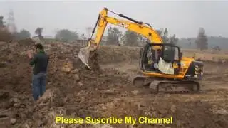 JCB Excavator Making Pond And Filled Clay On Tripper.