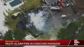Flames are bursting through the roof of a Concord mansion built over a century ago