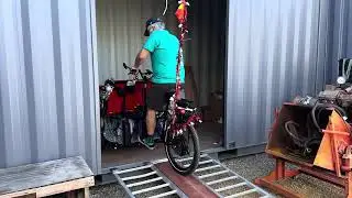 Unloading trishaw into shipping container
