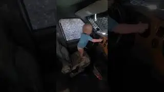 RV baby pretending to drive.