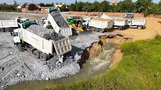 Attention! The giant lake landfill uses bulldozer to move rocks and dump trucks to transport them