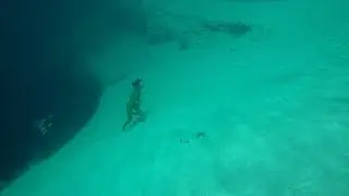 Diver Scales Hill Next To Deep Blue Hole