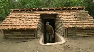 Building a shelter alone in a primeval forest and camping overnight by