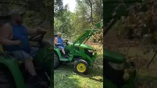 Root rake grapple on a John Deere 3039R