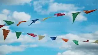 Flags fluttering on wind against blue sky