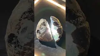 Crushing synthetic meteorite, reveals glowing, liquid crystal core