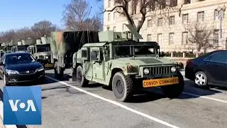 Military Vehicles Drive in Washington, Day After US Capitol Break-In
