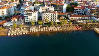 Dolly zoom. Marmaris, Turkey. Empty beach with rows of sunbeds and umbrellas in morning. Calm sea...