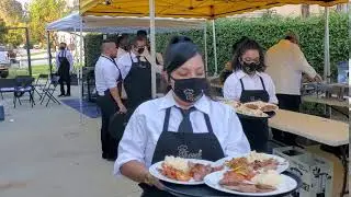 Servers Serving Wedding Dinner by Elegante Catering