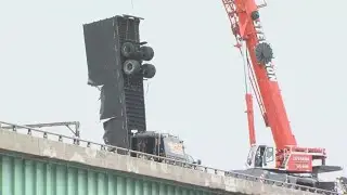 UPS truck dangles off overpass